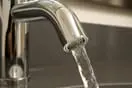 Save on Any Well Pump Replacement Water flowing from tap